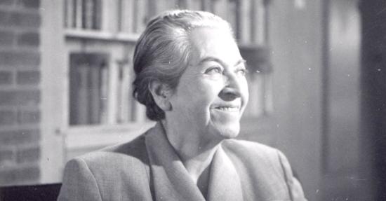 Gabriela Mistral sonriendo de perfil